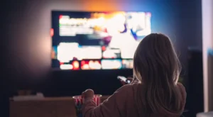 Relaxed woman watching TV without buffering